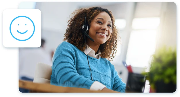 A Customer Success Manager wearing a headset, smiling while assisting a client